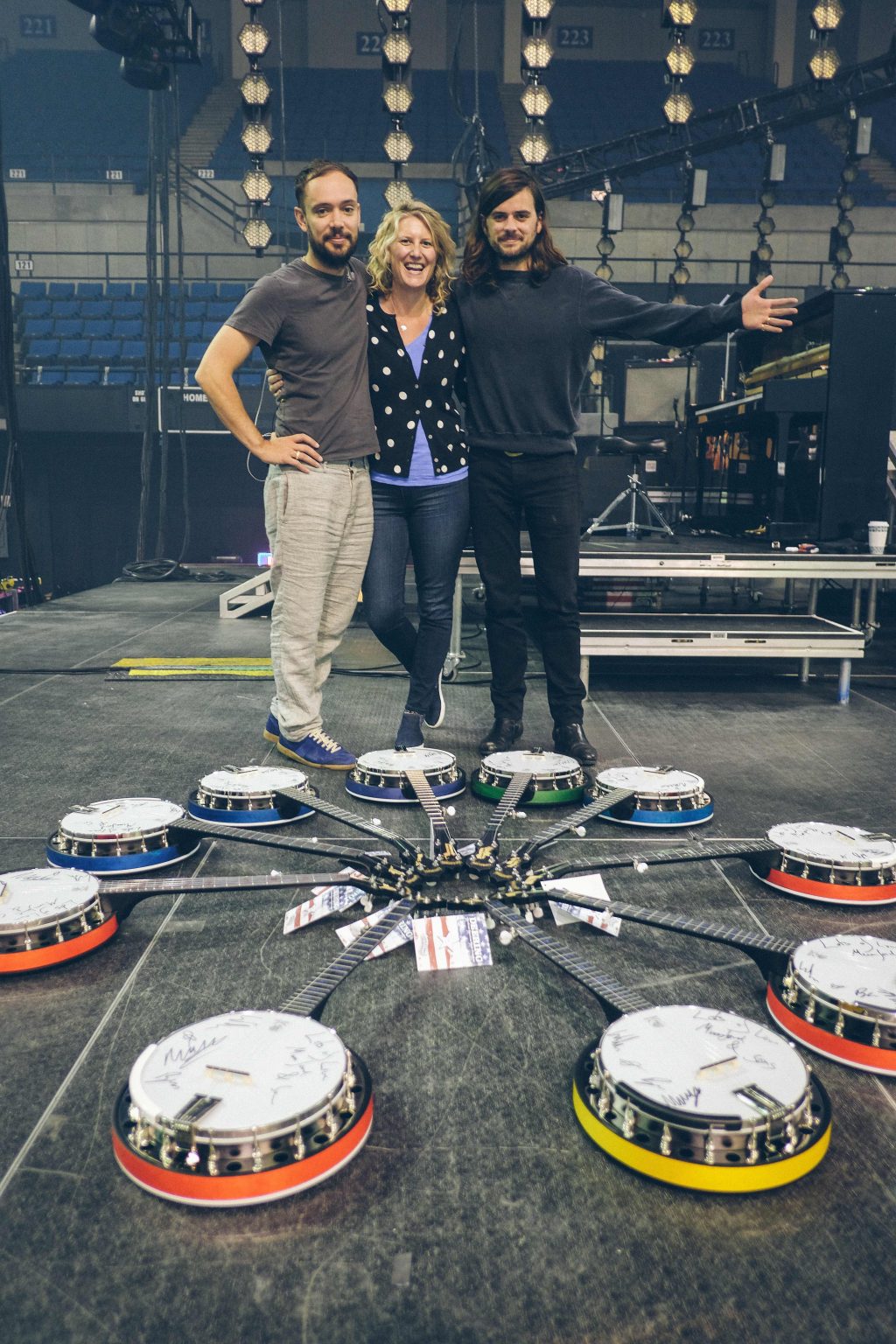 Ben Lovett, Jamie Deering and Winston backstage with banjo auction.